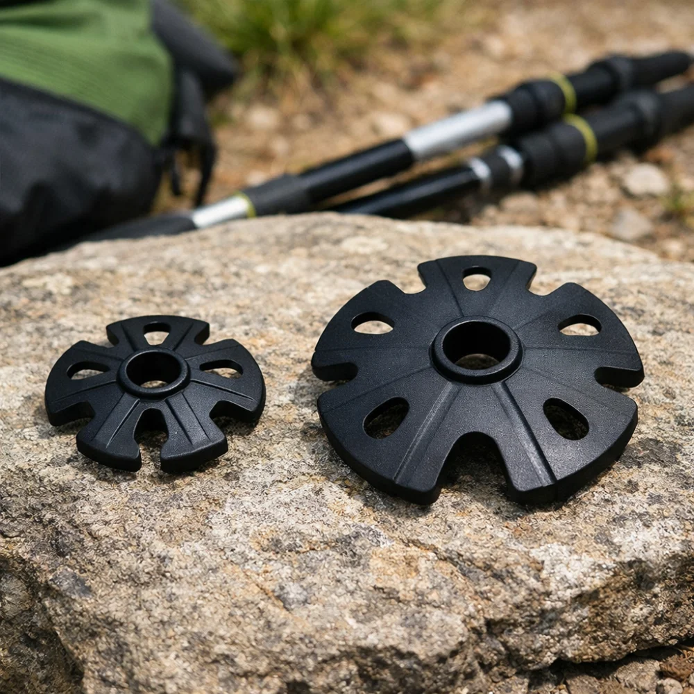 Two trekking pole baskets of different sizes shown side by side